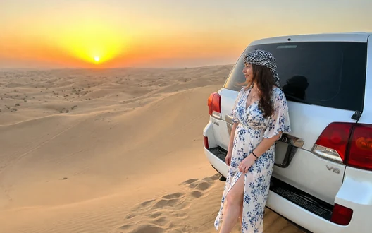 Guest photographing 4x4 dune bashing during an Abu Dhabi desert safari
