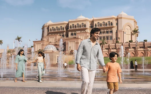 Family visiting Emirates Palace and its fountains during an Abu Dhabi city tour