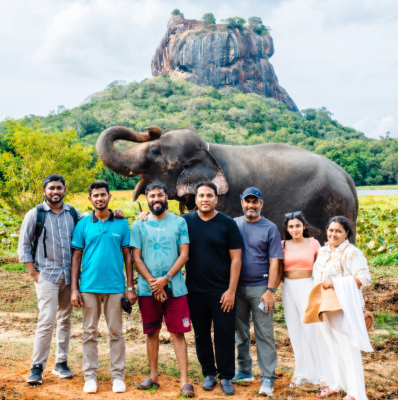 Seyed Shifaam with the Arabiers Colombo team and an elephant in front of Sigiriya Rock, Sri Lanka