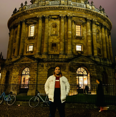 Seyed Shifaam standing in front of the Radcliffe Camera in Oxford at night