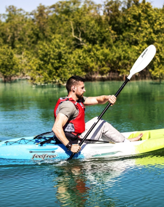 Kayaker paddling through calm Abu Dhabi mangrove waters, an outdoor activity experience reviewed by Seyed Shifaam for Arabiers
