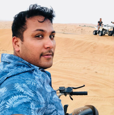 Seyed Shifaam seated on a quad bike on desert dunes in Ras Al Khaimah
