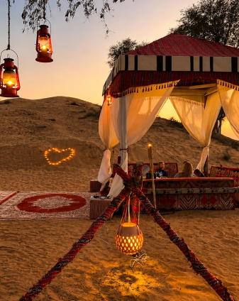 Golden Ras Al Khaimah desert camp at sunset, selected for Seyed Shifaam's desert safari content on Arabiers