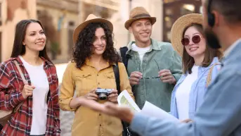 Arabiers staff delivering attraction tickets to a tour group in Dubai