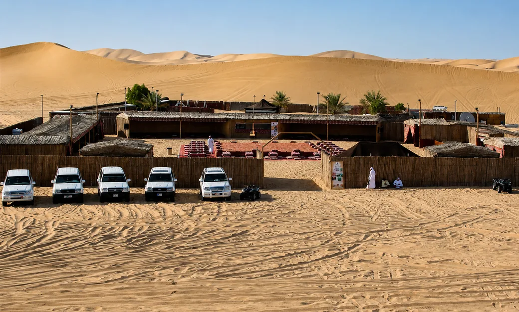 Traditional Abu Dhabi desert safari camp surrounded by dunes