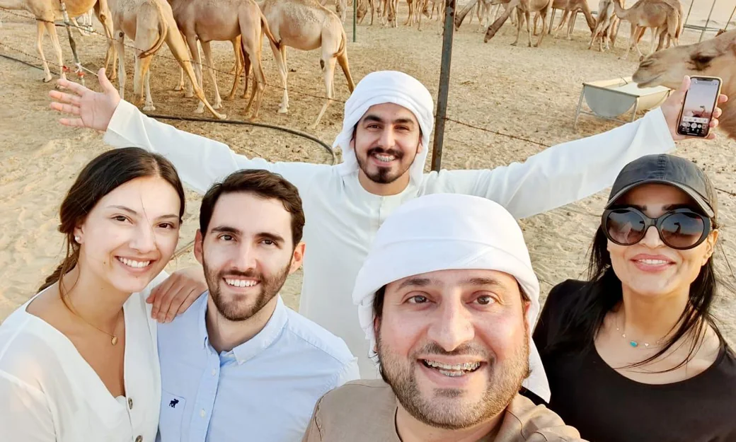 Guests taking a photo at an Abu Dhabi camel farm