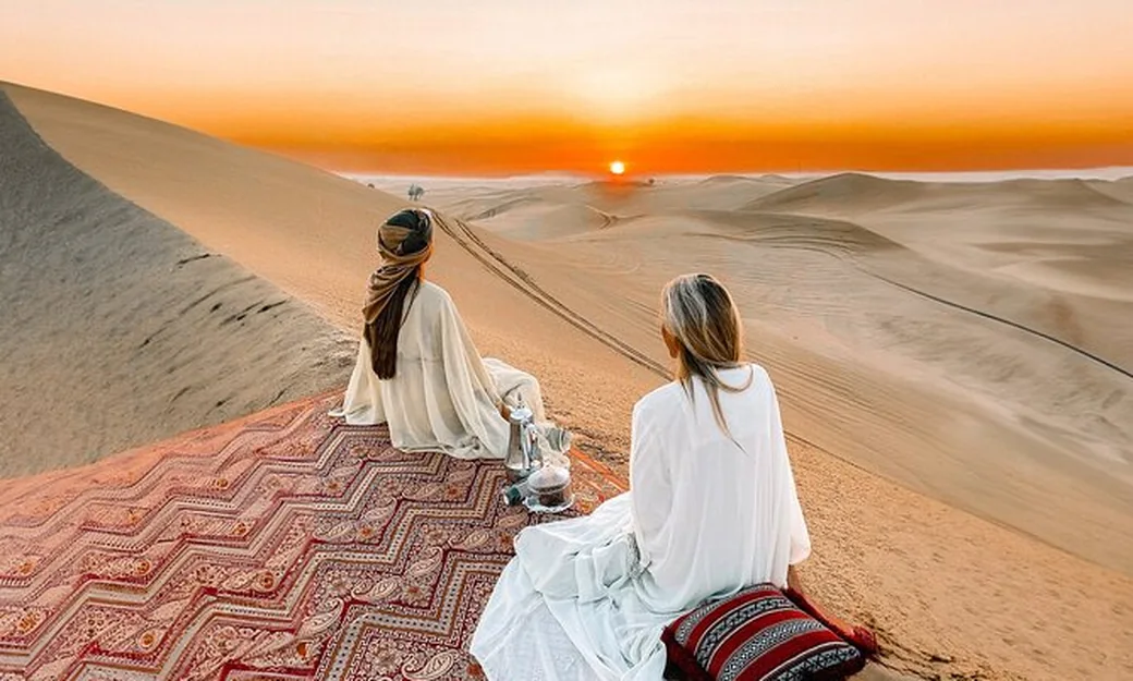 Guests seated in a desert majlis at sunset in Abu Dhabi