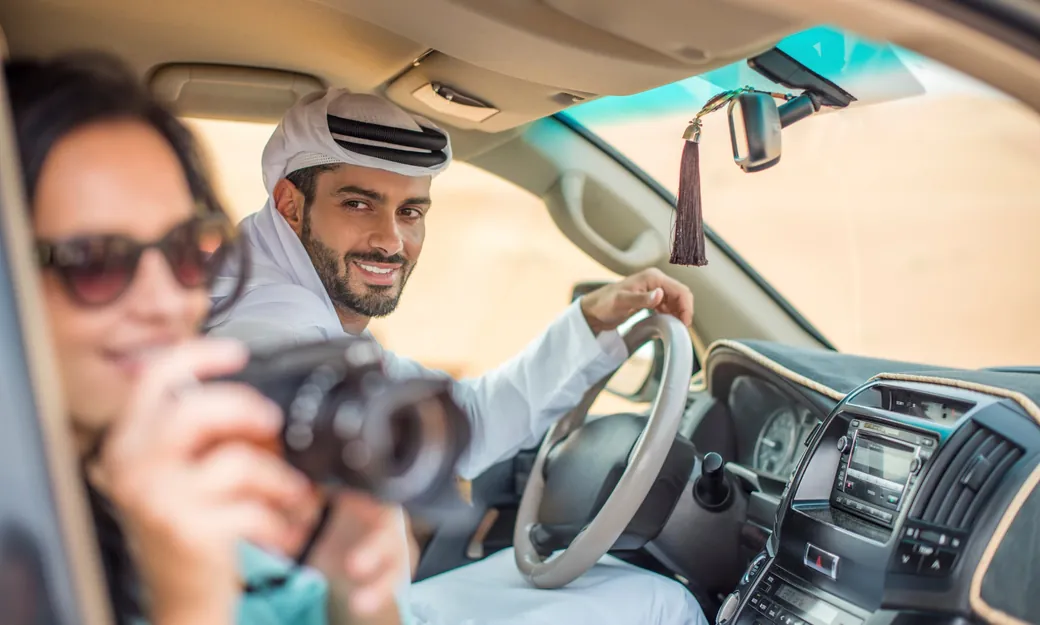 Traveller taking desert photos from a private 4x4