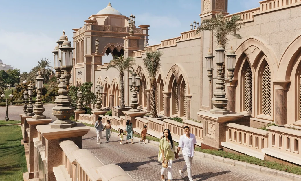 Visitors walking through the landscaped grounds of Emirates Palace Abu Dhabi