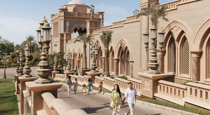 Visitors walking through the landscaped grounds of Emirates Palace Abu Dhabi