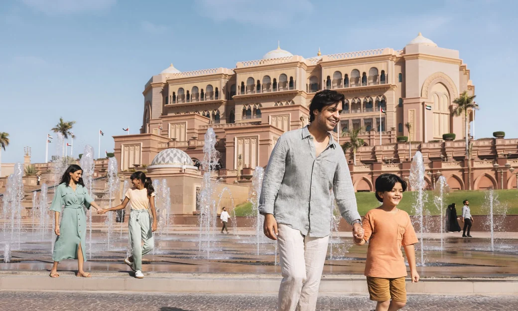 Family walking by the fountains at Emirates Palace in Abu Dhabi