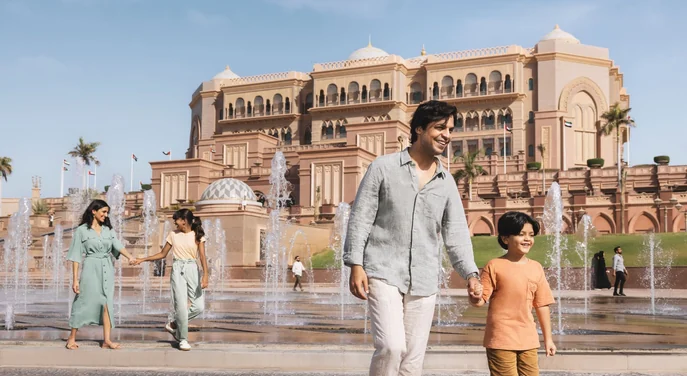 Family walking by the fountains at Emirates Palace in Abu Dhabi