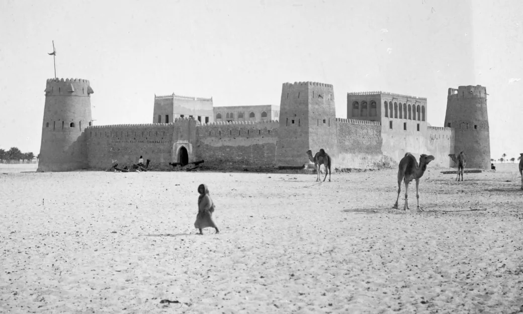 Historic Abu Dhabi fort and camels in the desert
