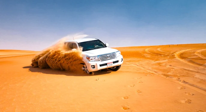 Toyota Land Cruiser dune bashing across the Liwa desert during a full day safari
