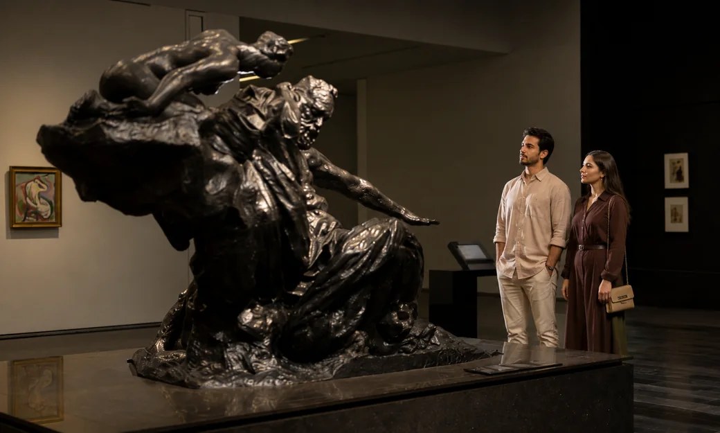 Visitors viewing a monumental sculpture inside Louvre Abu Dhabi