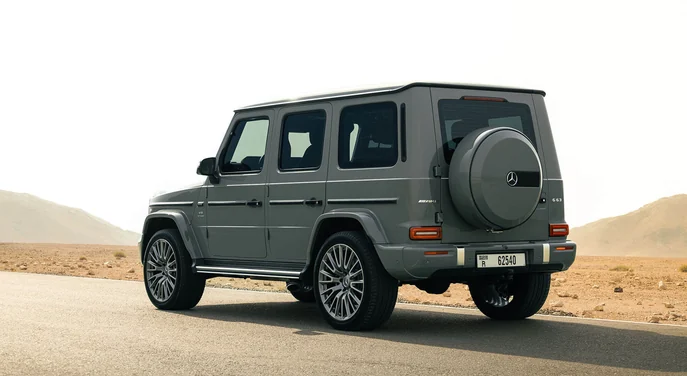 Rear view of a Mercedes G-Class on a desert road in Abu Dhabi