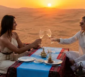 Friends sharing a private Sunset Dune Majlis dinner in Abu Dhabi