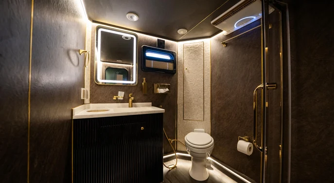 Gold-fitted vanity inside the air-conditioned VIP Mobile Washroom