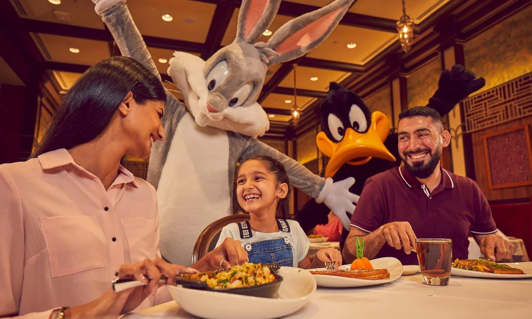 Family dining with Bugs Bunny and Daffy Duck at Warner Bros World Abu Dhabi