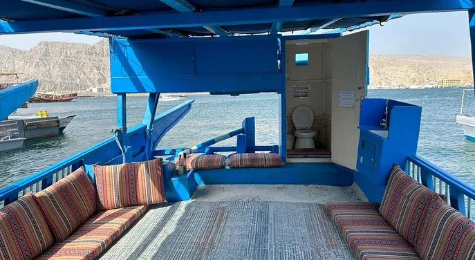 Traditional dhow seating area and onboard facilities in Khasab