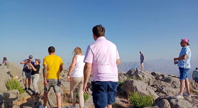 Guests exploring the rocky landscape near Jebel Harim during a Khasab mountain safari
