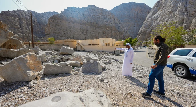 Local guide and traveller visiting the rocky landscape near Khasab