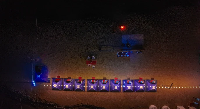 Aerial view of illuminated tents at a remote Musandam beach campsite