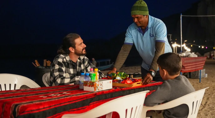 Guests having dinner at an overnight beach camp in Musandam