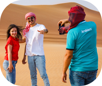 Group on an Abu Dhabi desert safari with a local Arabiers guide at sunset