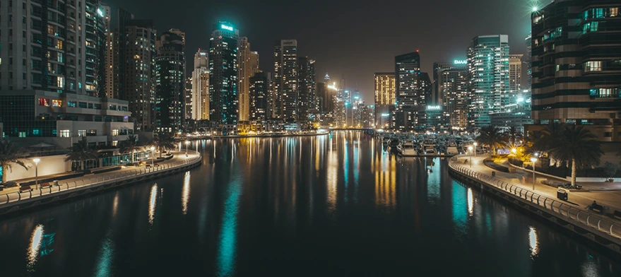 Dubai Marina skyline reflected on the water at night during a dhow cruise