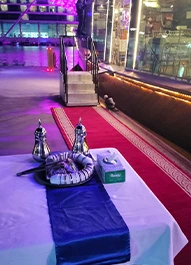 Dinner table set with welcome drinks on a Dubai Creek dhow cruise