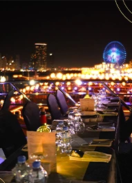 Buffet dinner table set with Dubai Marina skyline behind
