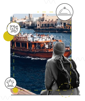 Traveller watching the Dubai skyline from a dhow at dusk
