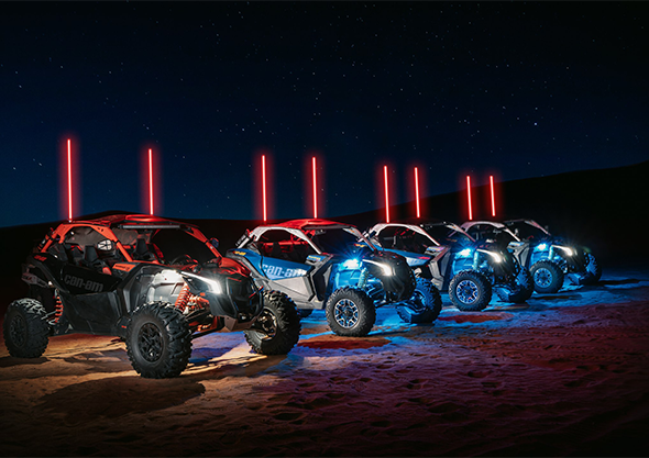 Dune buggies lit with LED whips lined up for a night ride in Dubai