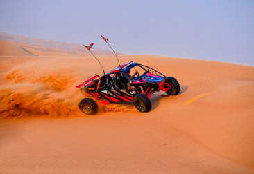 Beginner rider in a dune buggy on a gentle Dubai dune