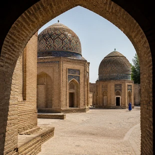 Historic tiled mausoleums viewed through an arched passage in Uzbekistan