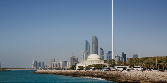 Kayaking along the Abu Dhabi Corniche waterfront with the city skyline behind