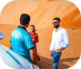 Couple with an Arabiers guide on a Liwa desert safari in the Empty Quarter