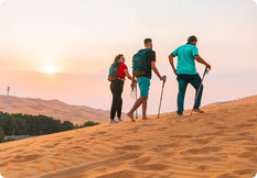 Group trekking across the high dunes of the Liwa Empty Quarter