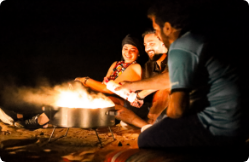 Private overnight desert camp set among the Liwa dunes at dusk