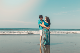 Couple walking along a quiet beach in Sri Lanka at sunset